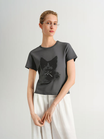 Woman wearing a dark gray t-shirt with a black cat design on a light gray background